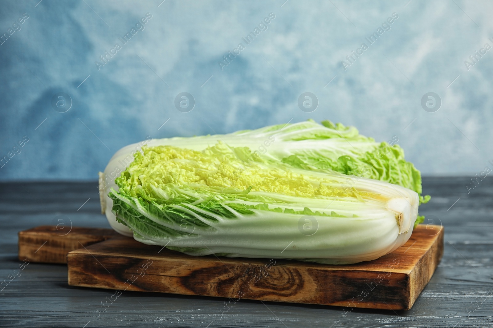 Photo of Fresh ripe cabbages on wooden board