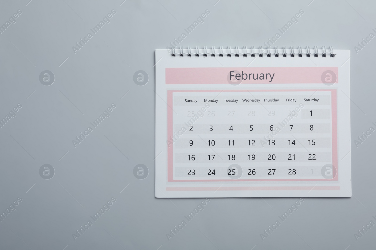 Photo of Paper calendar on light grey background, top view. Space for text