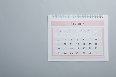 Photo of Paper calendar on light grey background, top view. Space for text