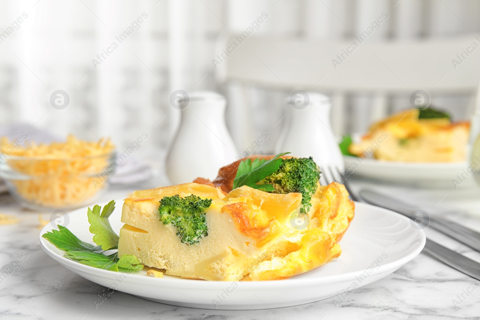 Photo of Tasty broccoli casserole served on white marble table indoors. Space for text