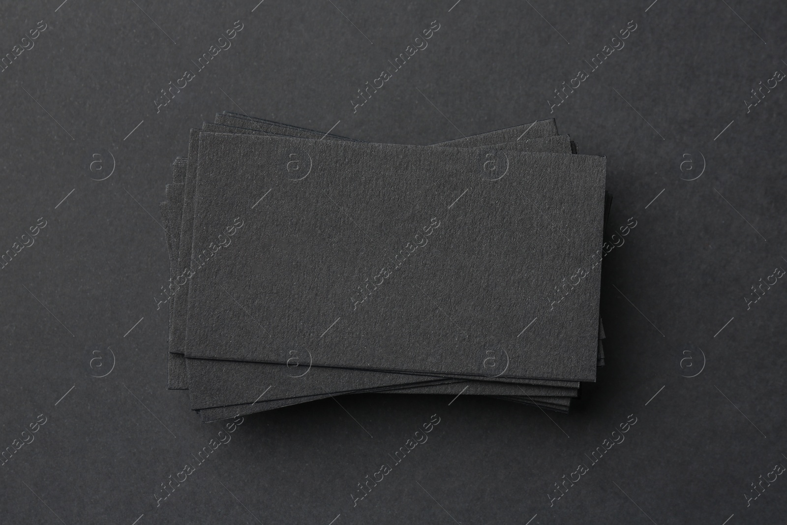 Photo of Blank business cards on black background, top view. Mockup for design