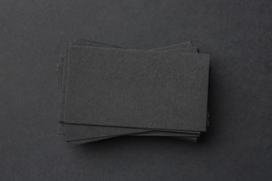 Blank business cards on black background, top view. Mockup for design