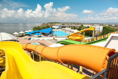 Photo of View from colorful slides in water park on sunny day