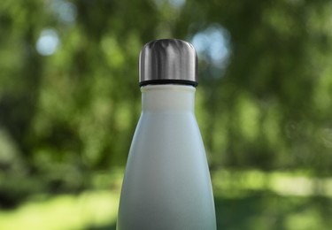 Photo of Closeup view of thermo bottle in park