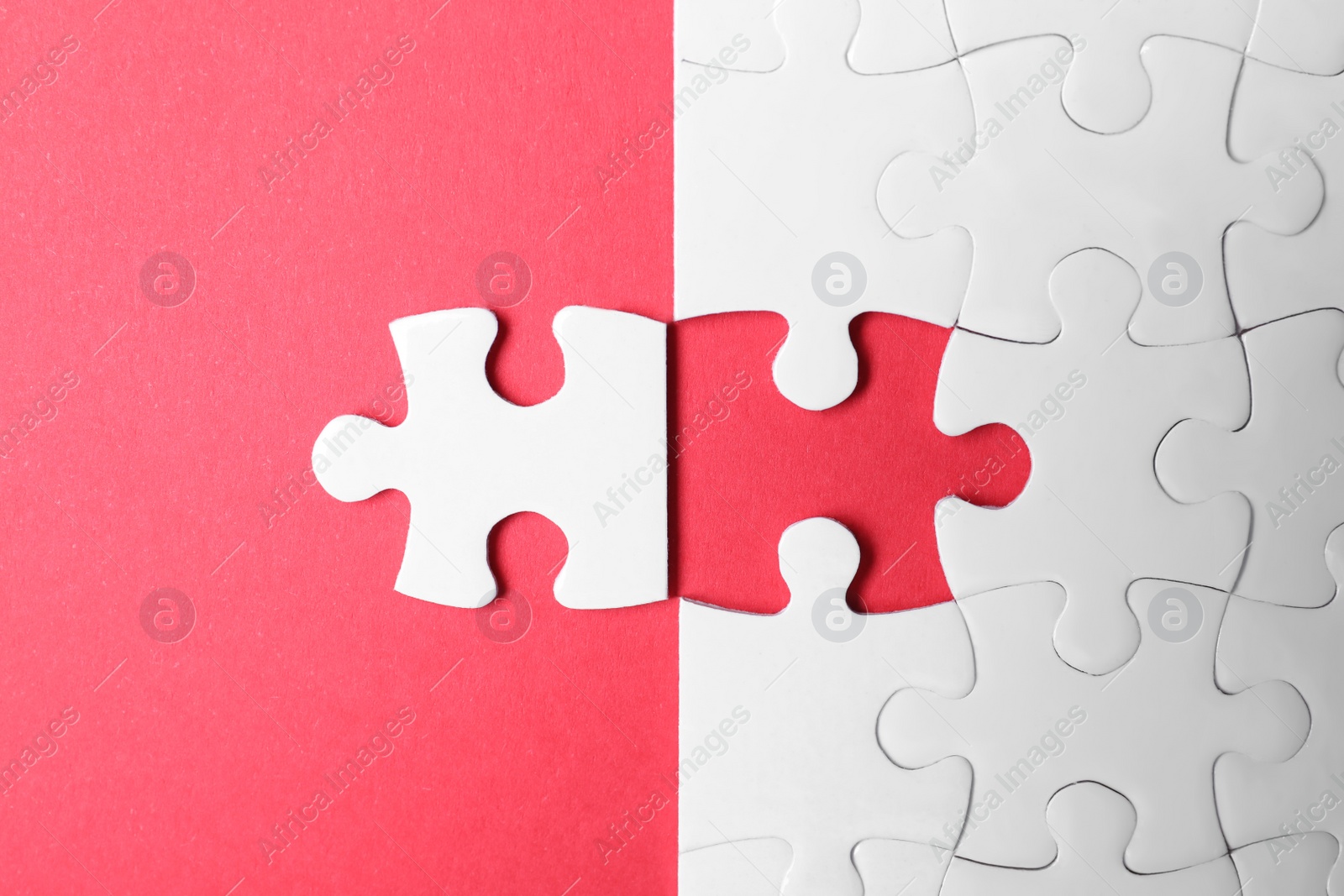 Photo of Blank white puzzle with separated piece on red background, flat lay