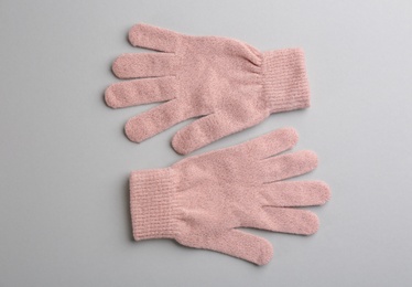 Pair of stylish woolen gloves on light grey background, flat lay