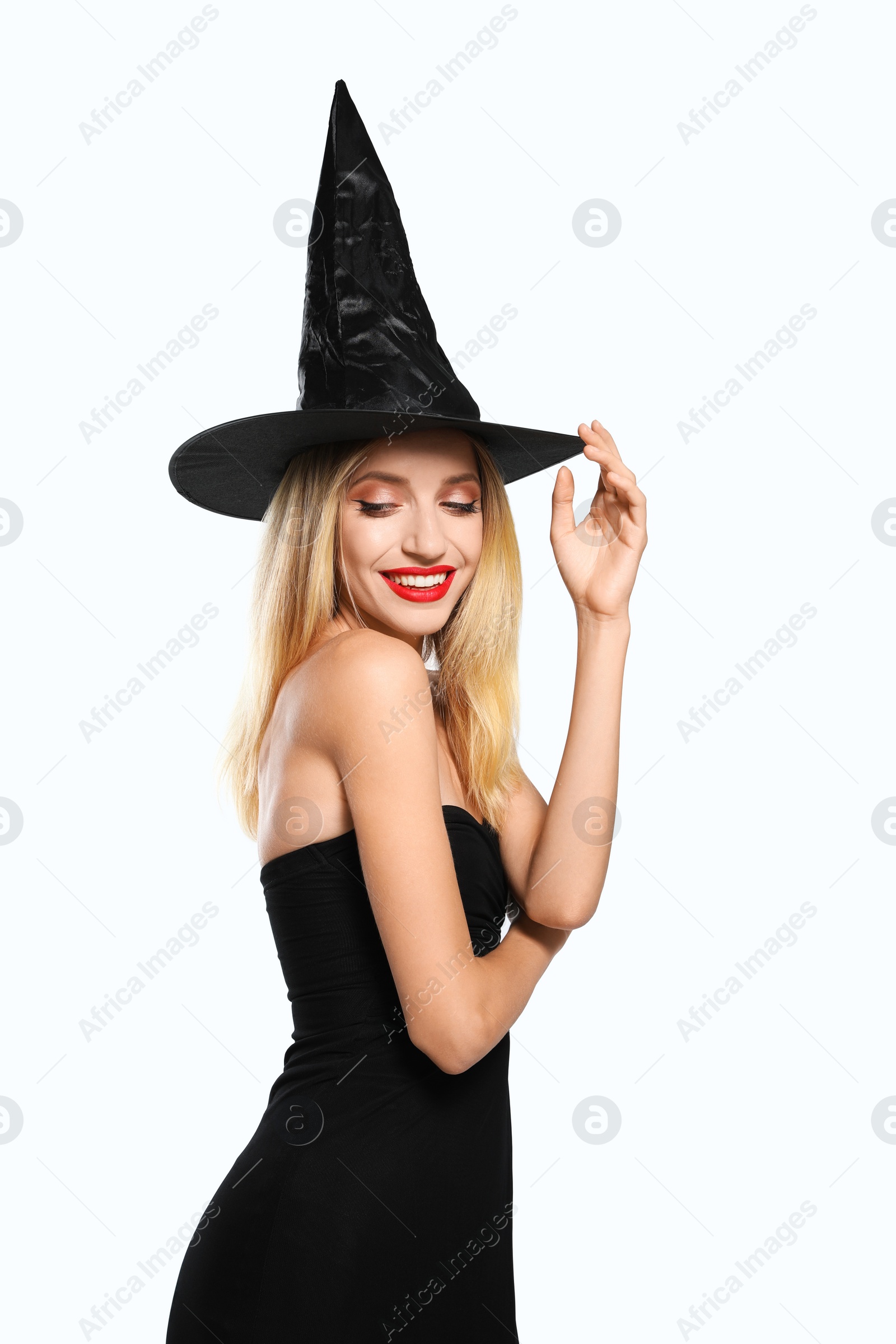 Photo of Beautiful woman in witch costume on white background. Halloween party