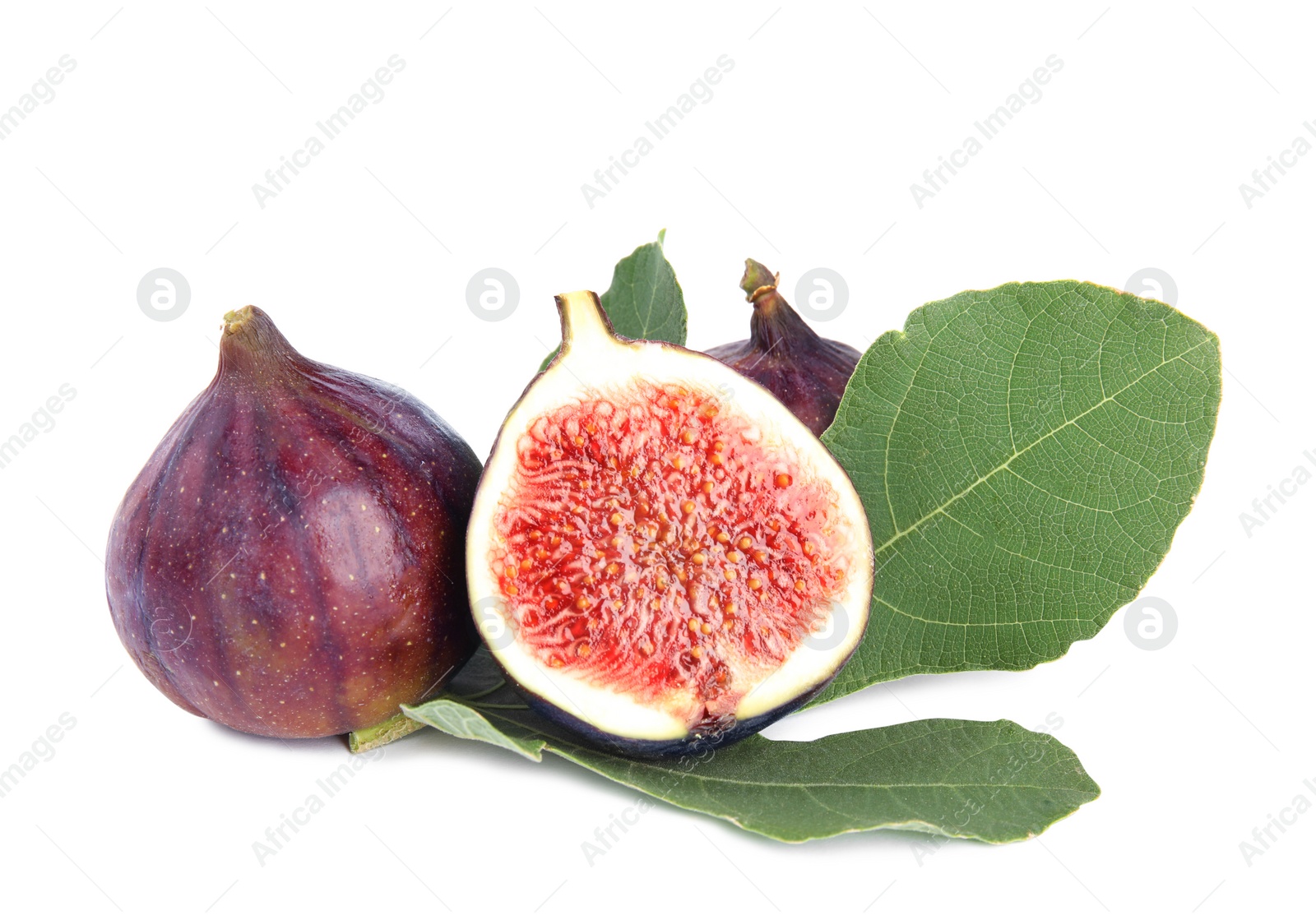 Photo of Fresh juicy purple figs and green leaves on white background