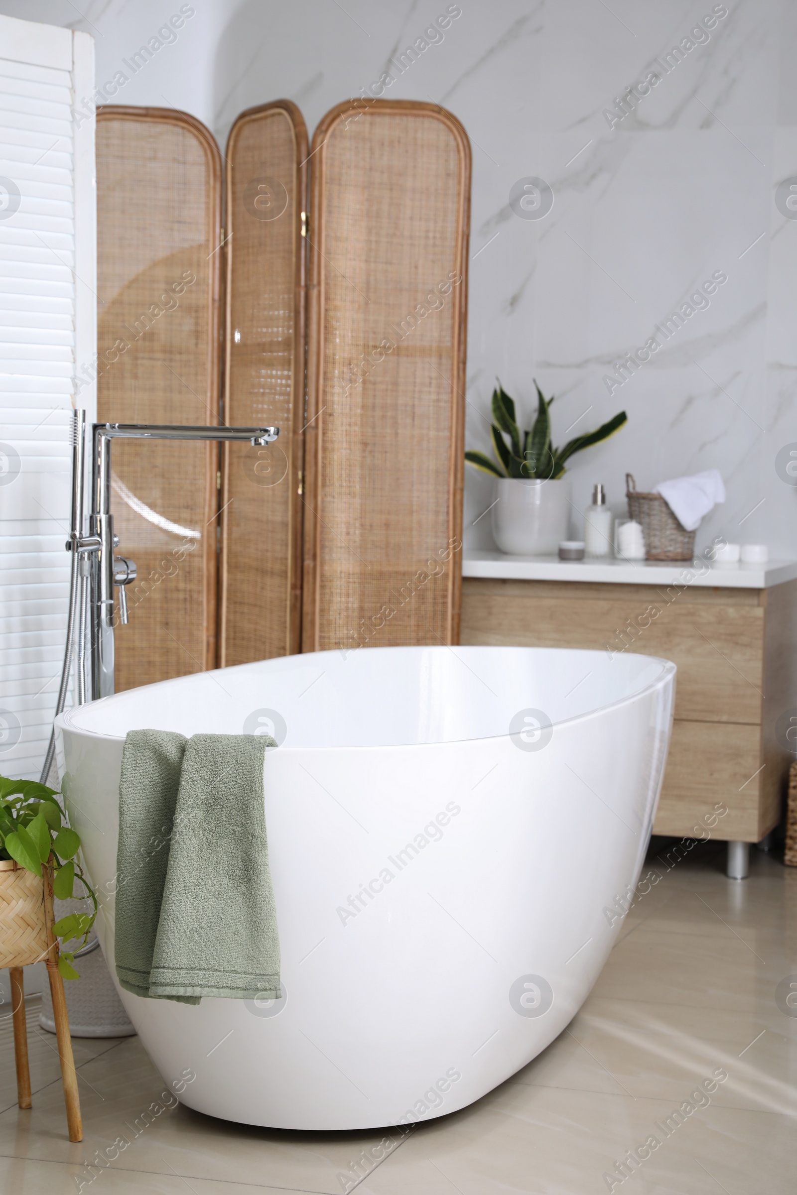 Photo of Modern white tub in bathroom. Interior design