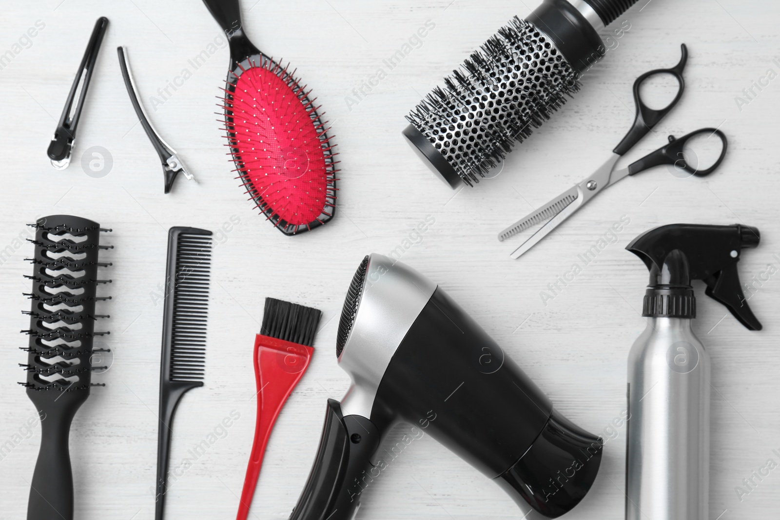 Photo of Flat lay composition with professional hairdresser tools on wooden background