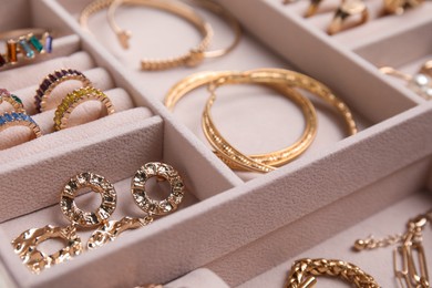 Photo of Jewelry box with stylish golden bijouterie, closeup view