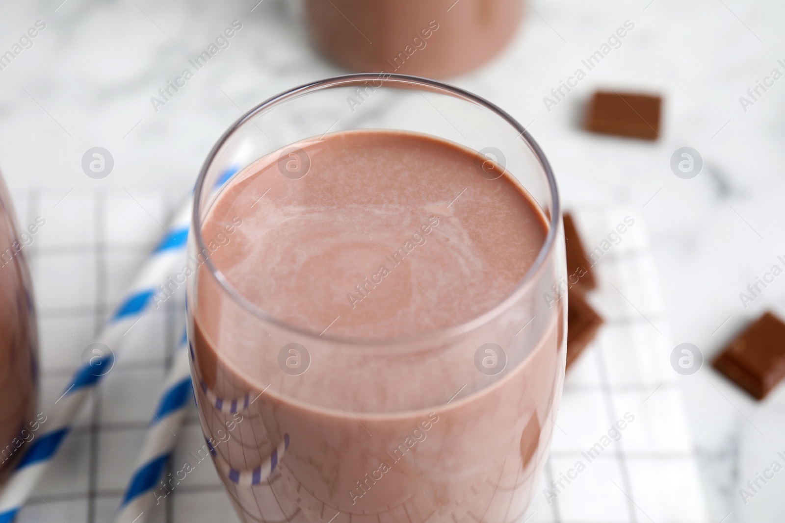 Photo of Delicious chocolate milk in glass, closeup view