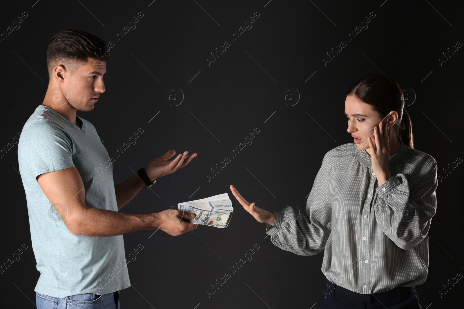 Photo of Woman refusing to take bribe on black background