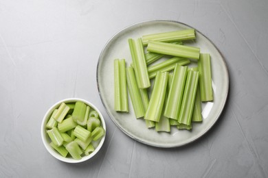 Fresh green cut celery on light grey table, flat lay