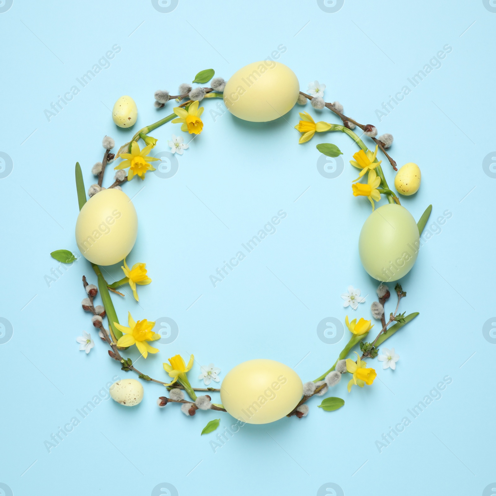 Photo of Frame made with Easter eggs on light blue background, top view. Space for text