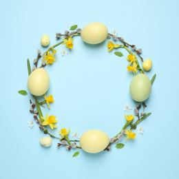 Photo of Frame made with Easter eggs on light blue background, top view. Space for text