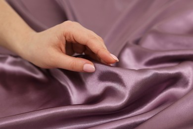 Photo of Woman touching smooth silky fabric, closeup view