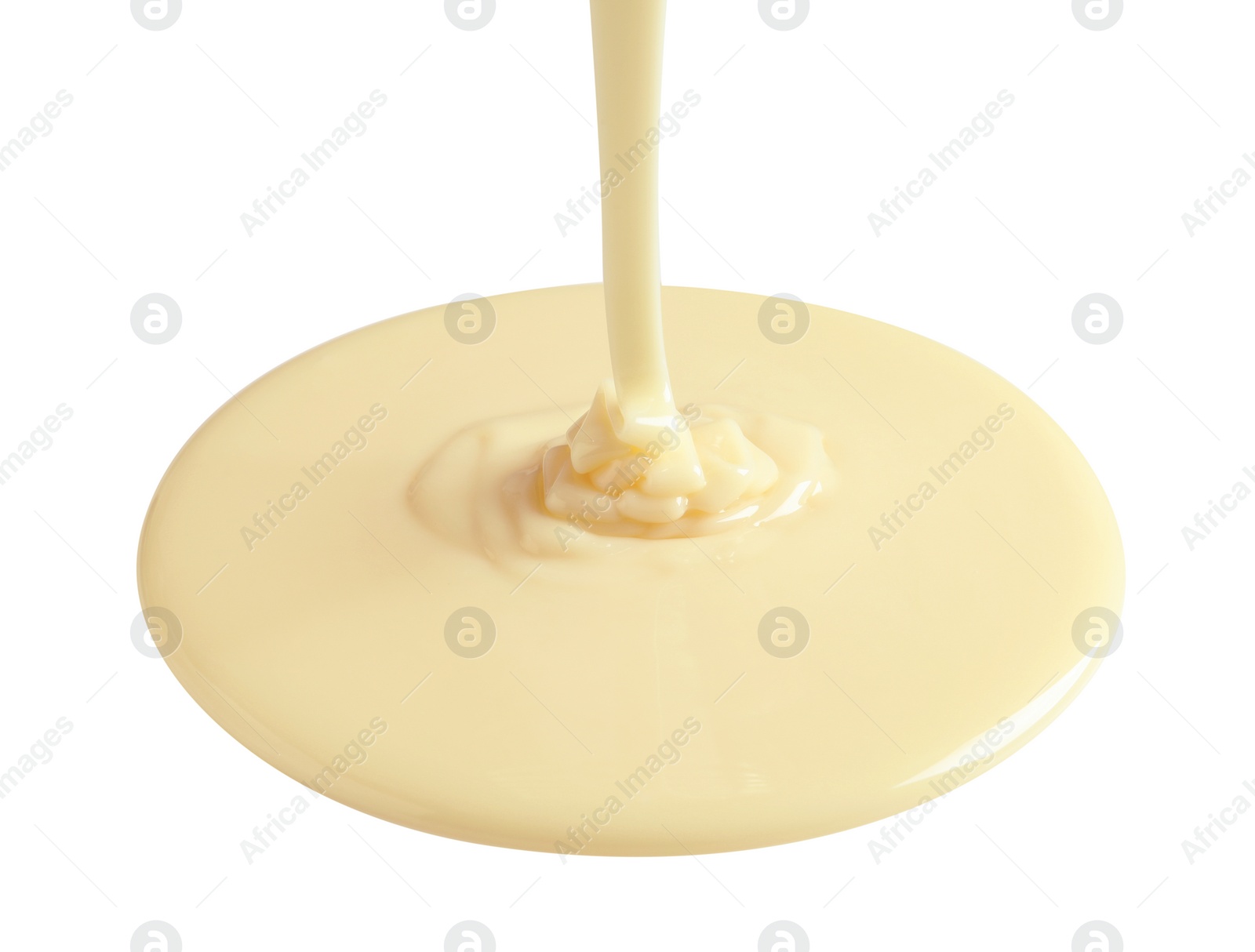 Photo of Tasty pouring condensed milk on white background. Dairy product