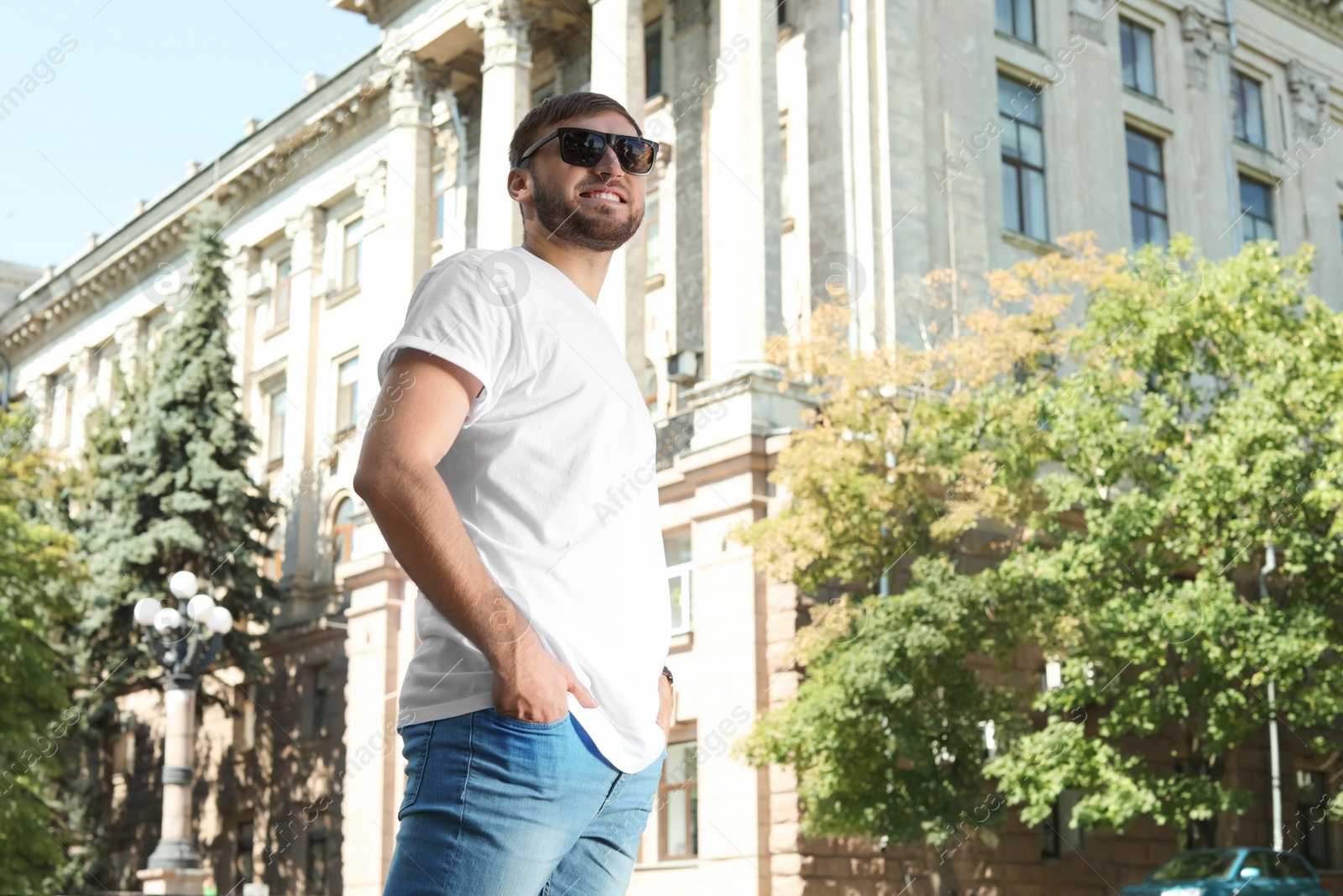 Photo of Young man wearing white t-shirt on street