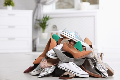 Photo of Pile of female shoes on floor indoors