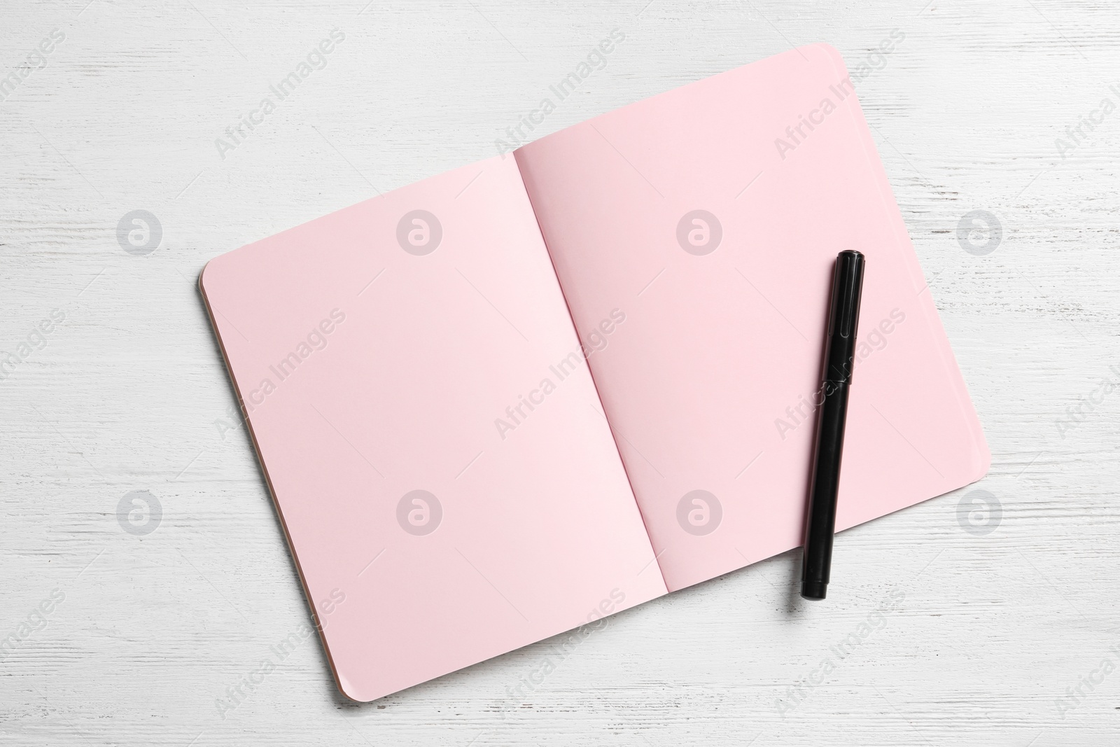 Photo of Notebook and marker on white wooden background, space for text. Sex education
