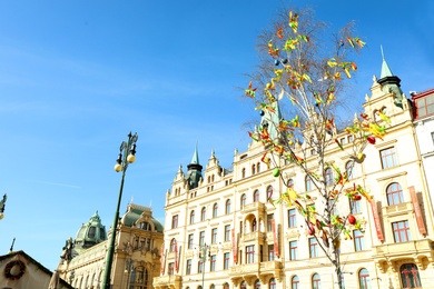 PRAGUE, CZECH REPUBLIC - APRIL 25, 2019: Decorated Easter tree in front of Hotel Kings Court. Space for text