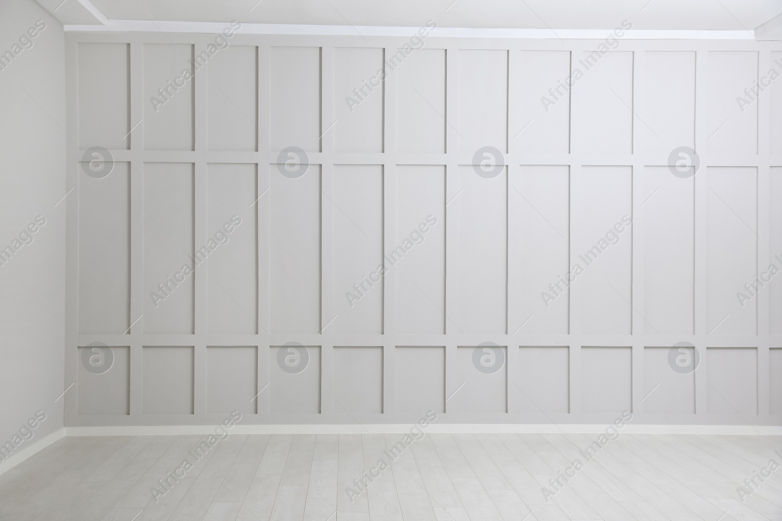 Photo of Empty spacious room with white wooden floor and walls
