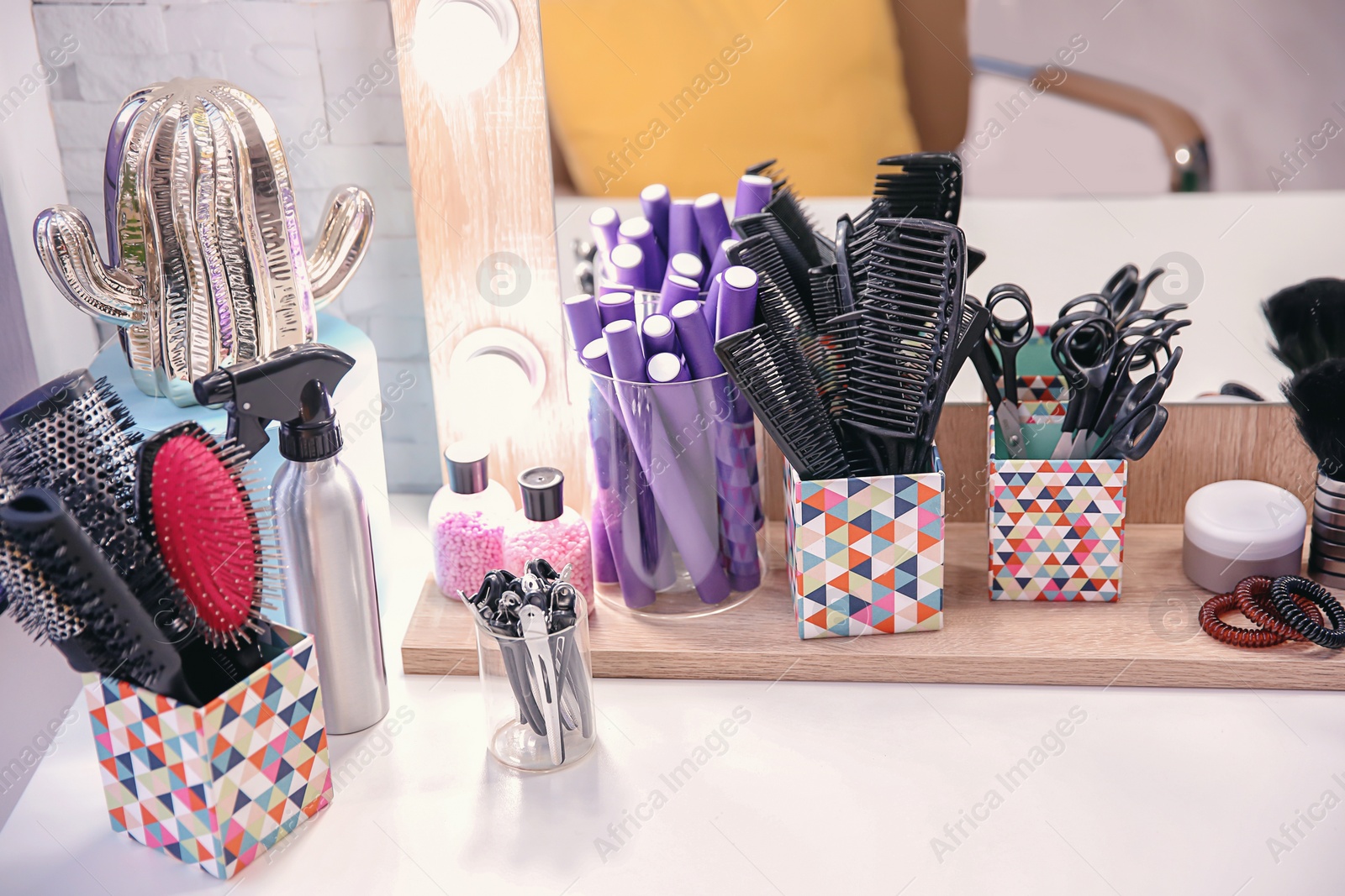 Photo of Set of hairdresser tools on table in salon