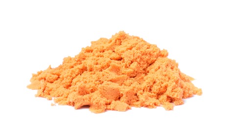 Photo of Pile of orange kinetic sand on white background