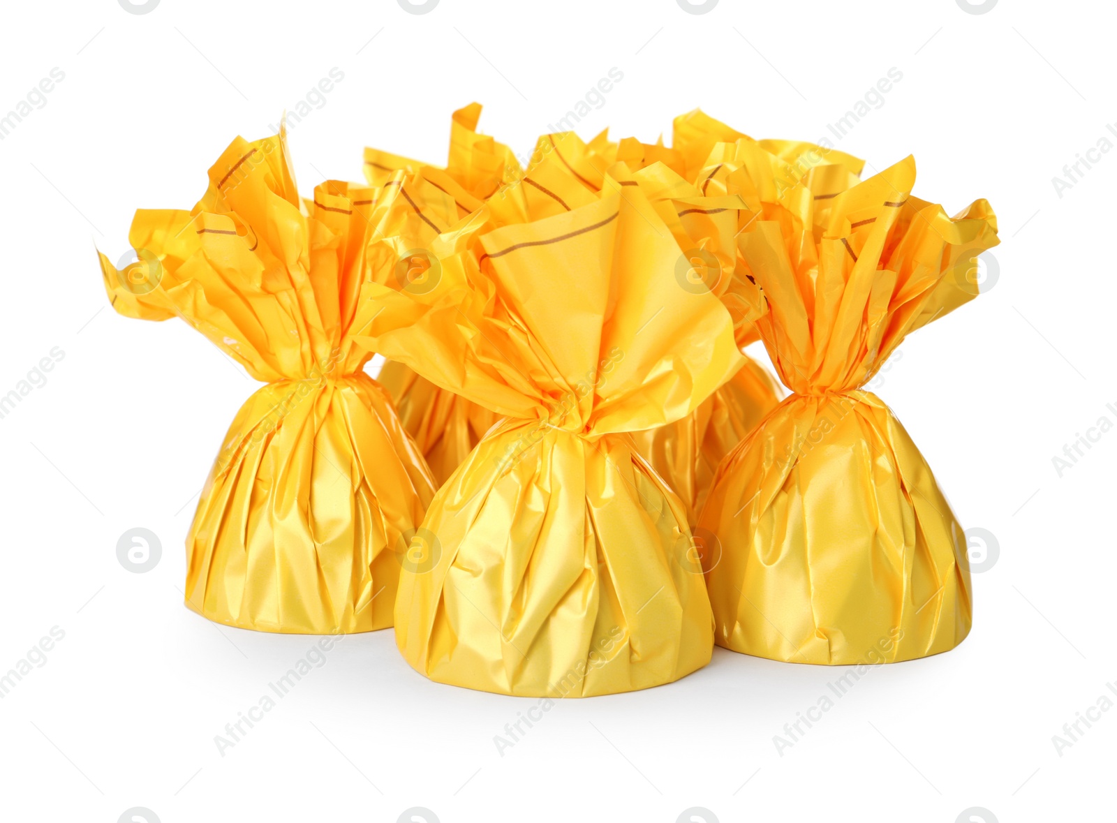 Photo of Delicious candies in yellow wrappers on white background