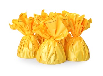 Photo of Delicious candies in yellow wrappers on white background