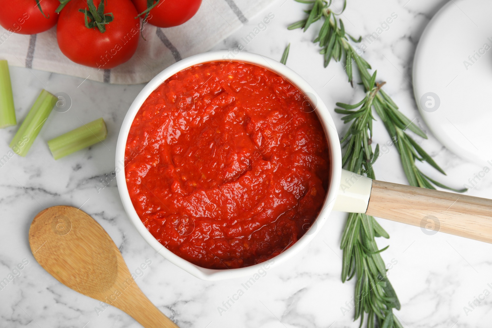 Photo of Flat lay composition with delicious tomato sauce on marble table