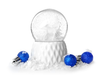 Photo of Magical snow globe with Christmas balls on white background