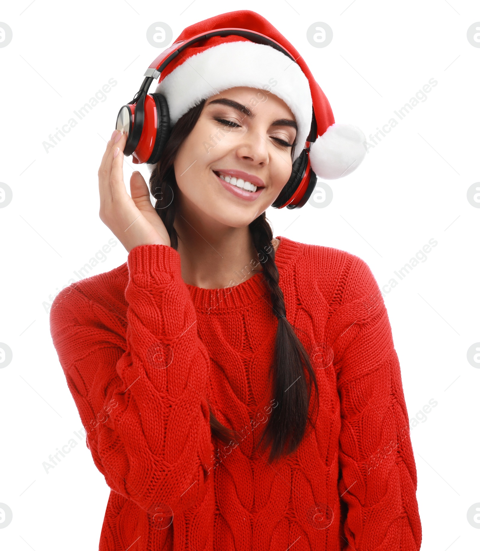 Photo of Young woman in Santa hat listening to Christmas music on white background