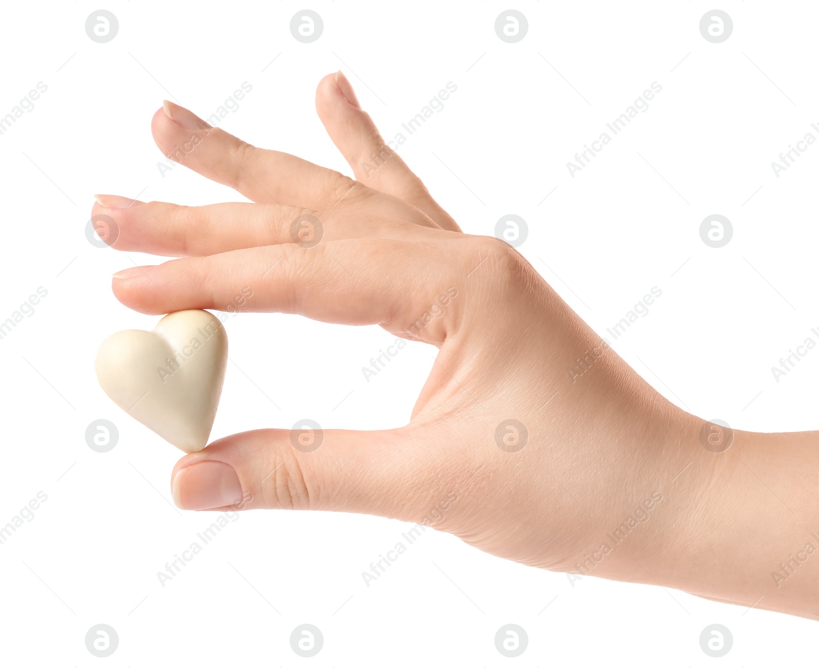 Photo of Woman holding heart shaped chocolate candy on white background, closeup