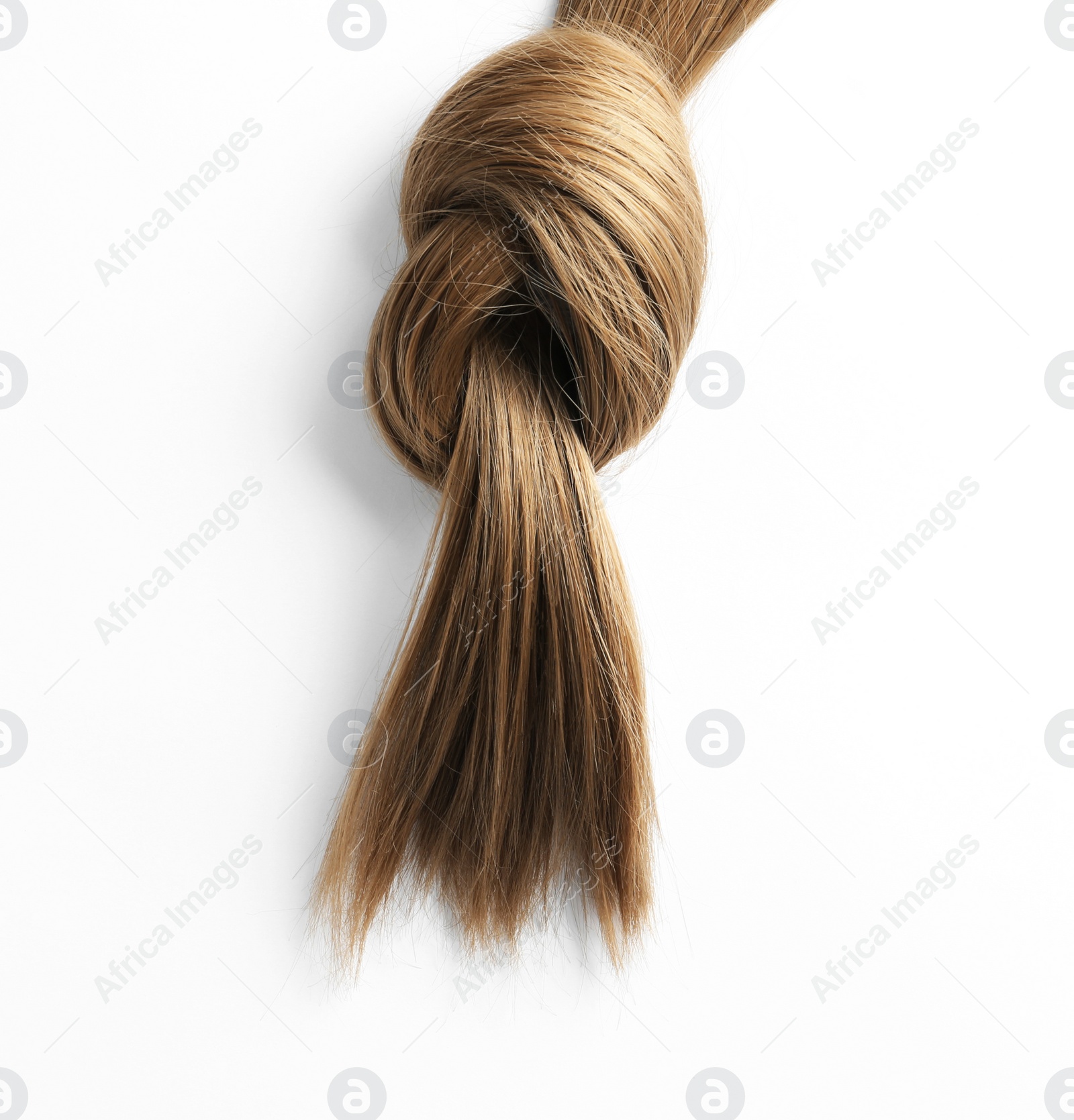 Photo of Beautiful strand of brown hair tied in knot on white background, top view. Hairdresser service