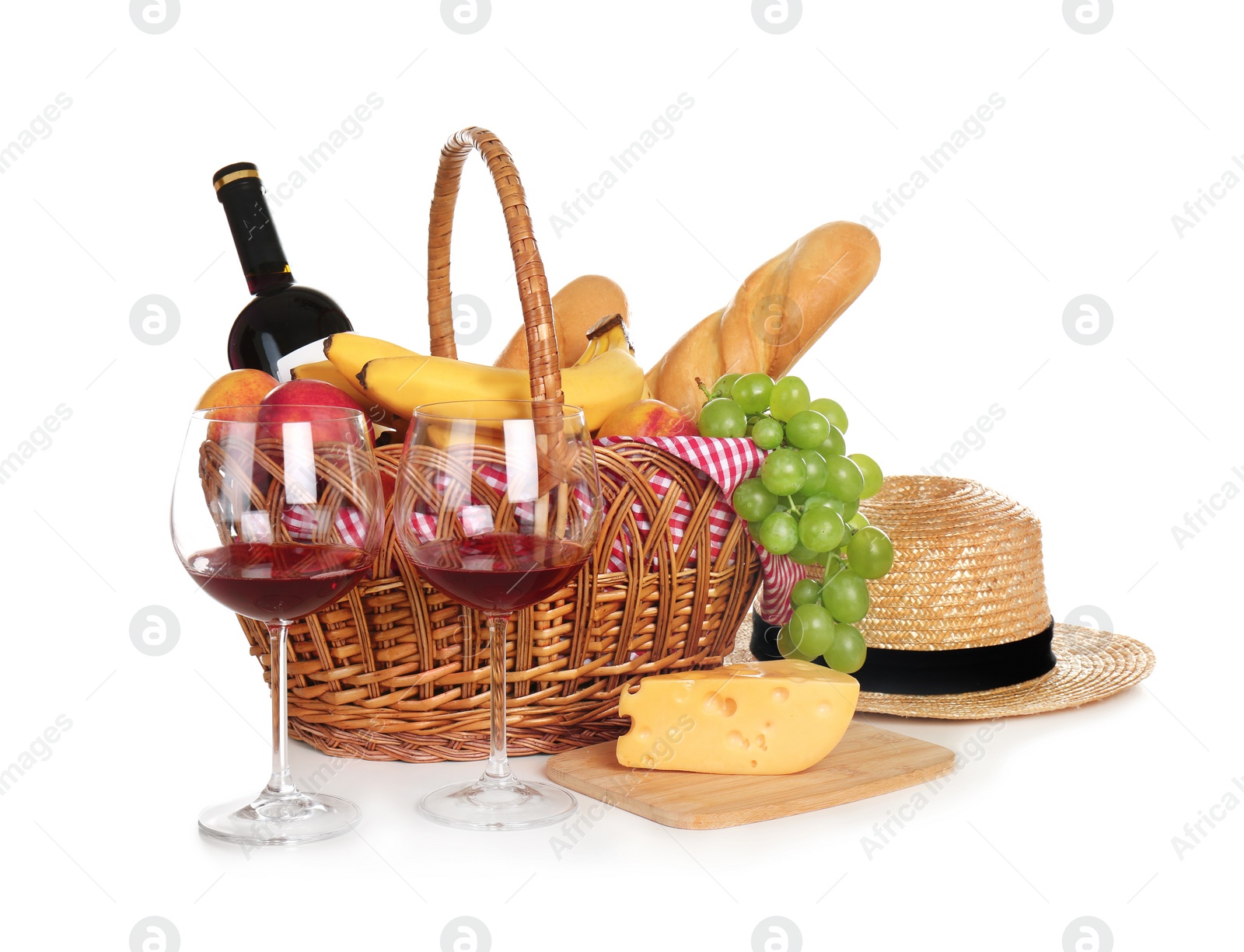 Photo of Picnic basket with food and glasses of wine on white background