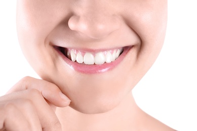 Young woman with beautiful smile on white background, closeup