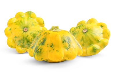 Three fresh yellow pattypan squashes on white background