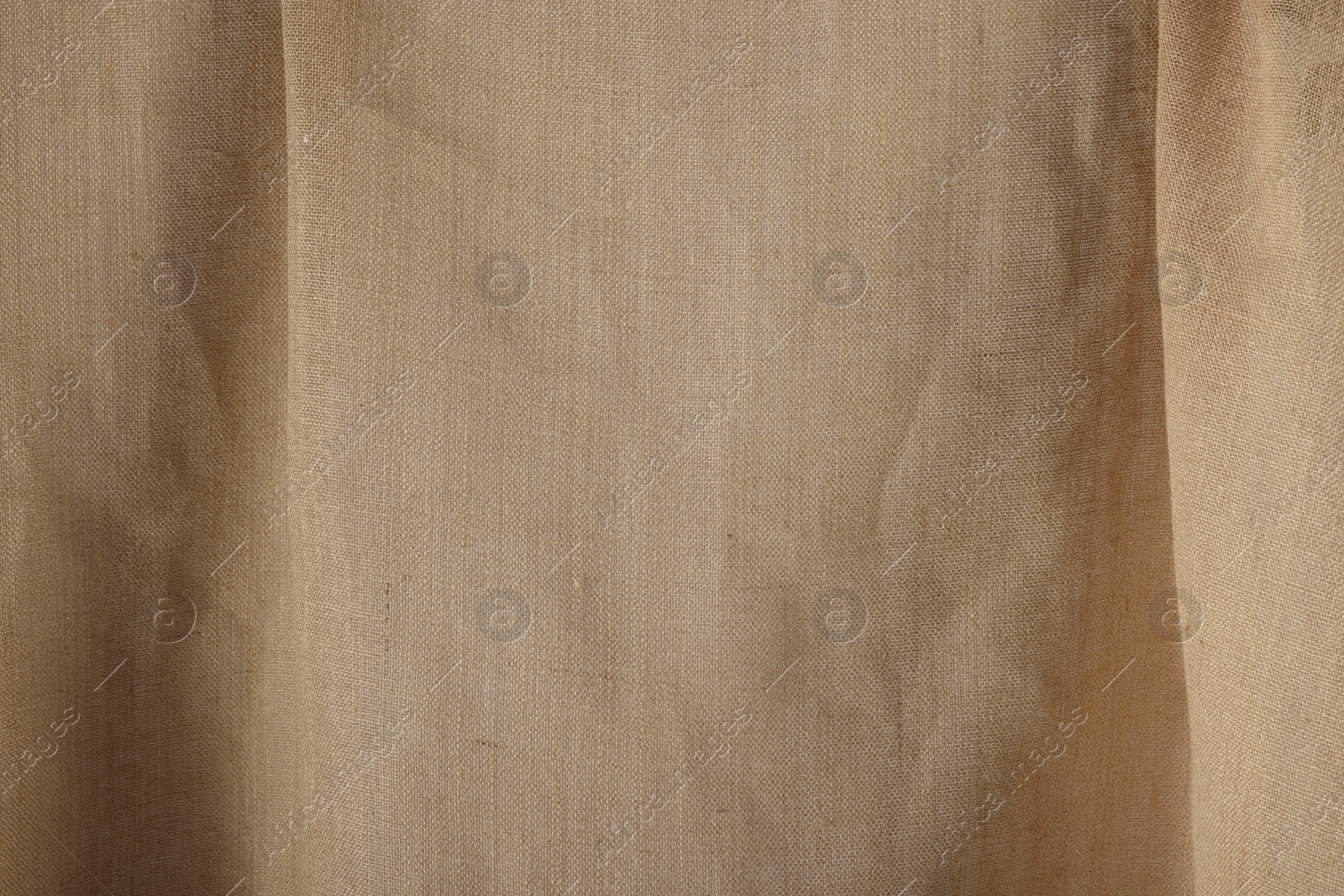 Photo of Texture of natural burlap fabric as background, closeup