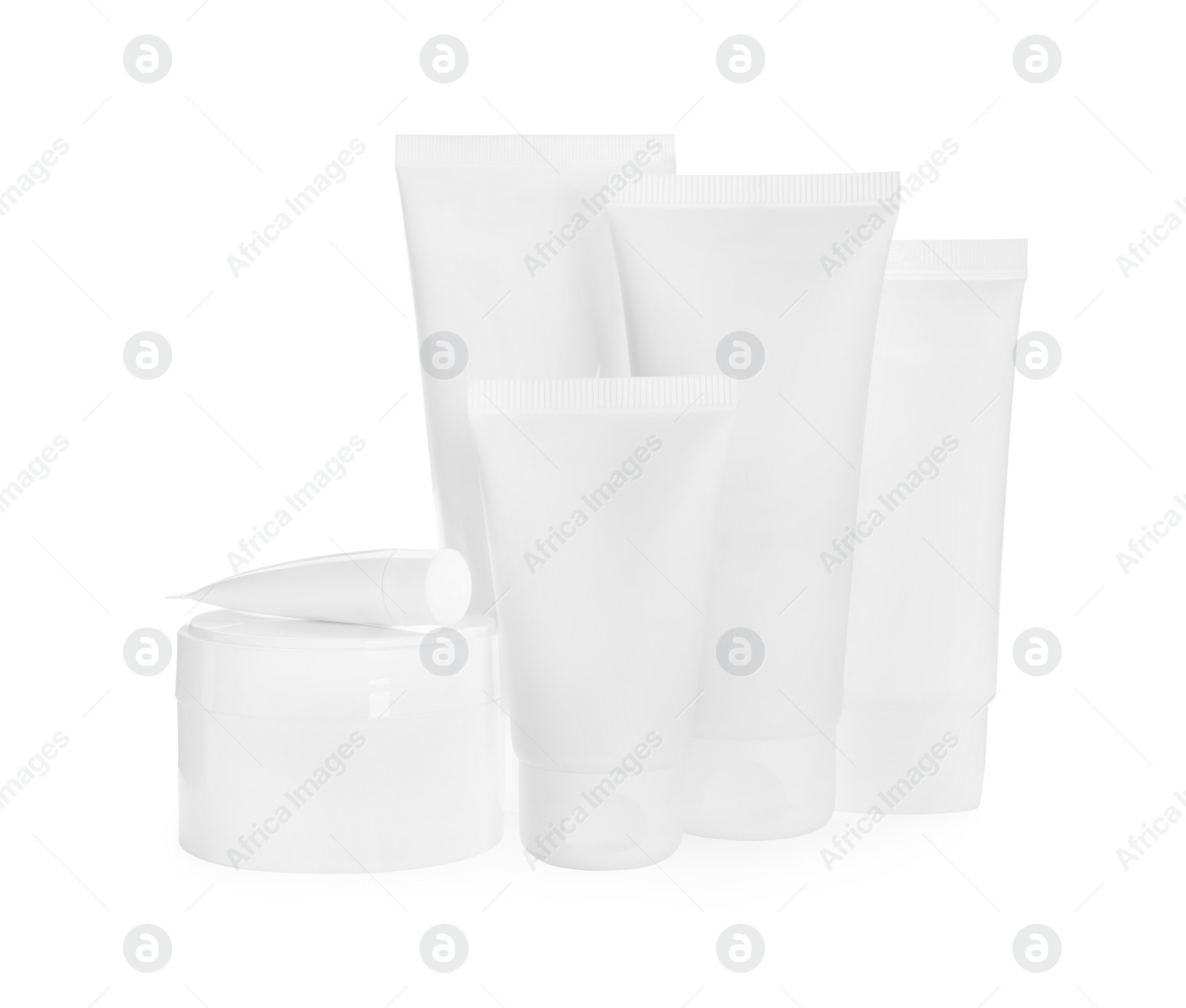 Photo of Blank tubes and jars of cosmetic products on white background