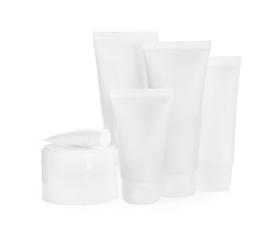 Photo of Blank tubes and jars of cosmetic products on white background