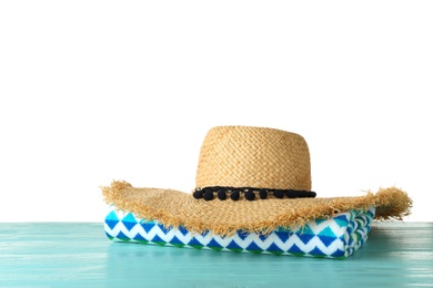 Photo of Towel and hat on table against white background, space for text. Beach accessories