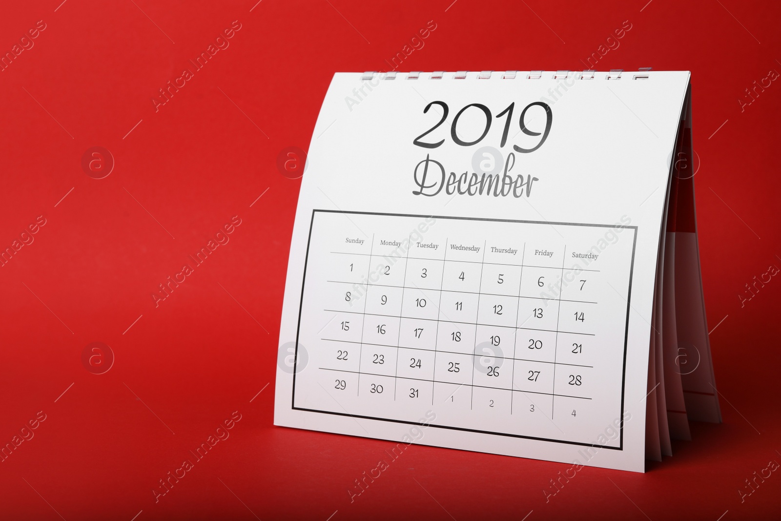 Photo of Paper calendar on red background. Planning concept