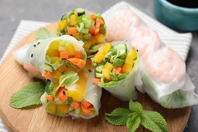 Photo of Tasty spring rolls on grey table, closeup