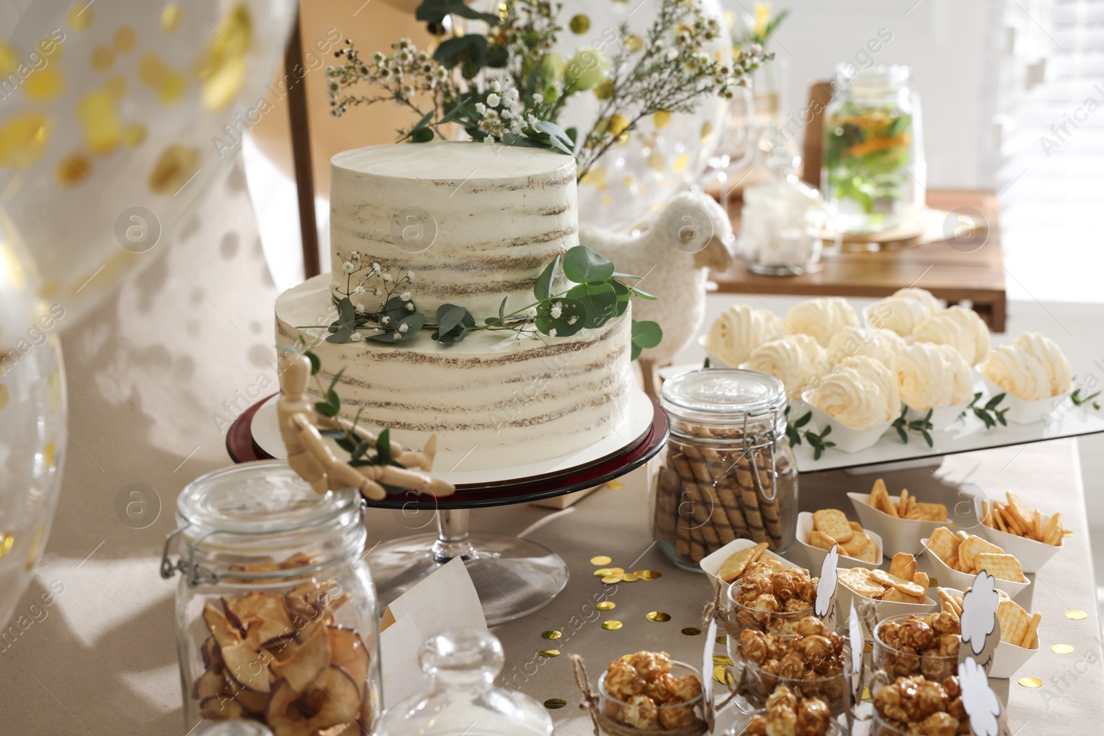 Photo of Beautiful cake and other treats on table in room. Baby shower party