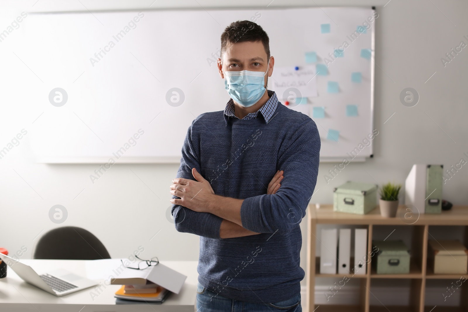 Photo of Teacher with protective mask in classroom. Reopening after Covid-19 quarantine