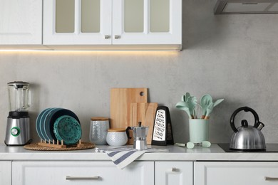 Photo of Set of different utensils and dishes on countertop in kitchen