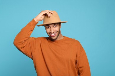 Portrait of happy African American man on light blue background