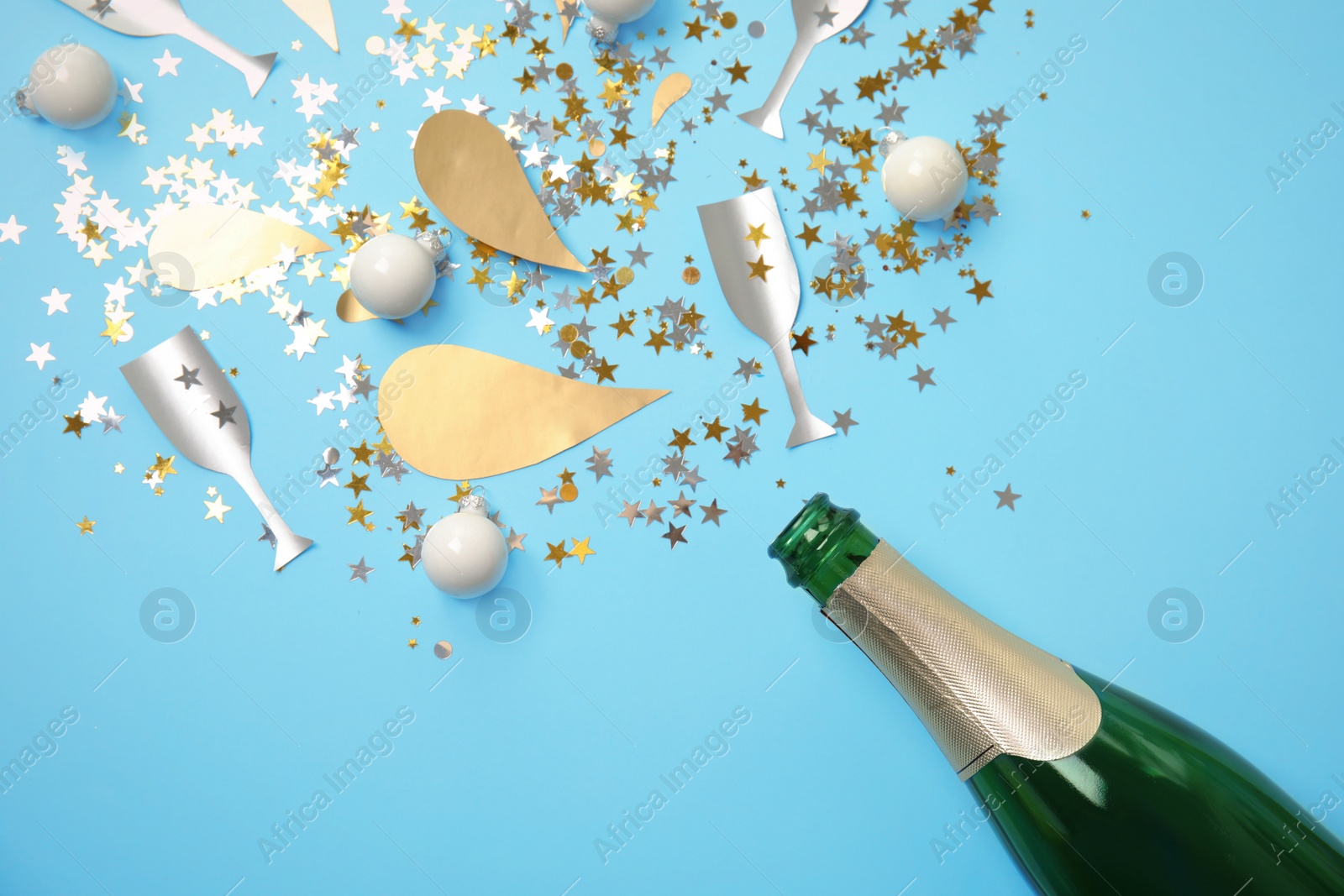 Photo of Creative flat lay composition with bottle of champagne on color background